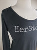 HerStory. Long Sleeved Tee in Graphite + White Lettering