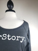 HerStory. Long Sleeved Tee in Graphite + White Lettering